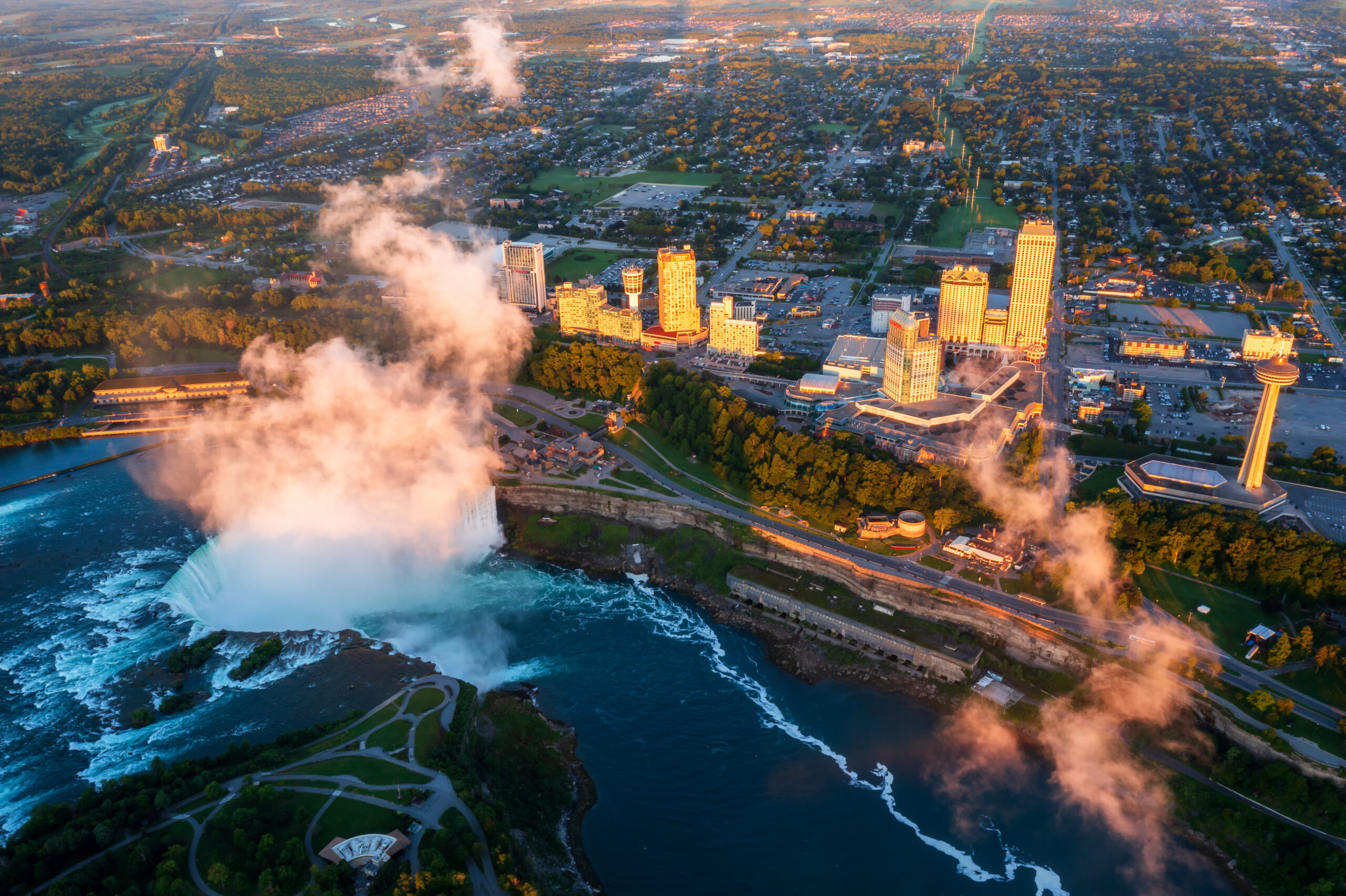 Aerial view of Niagara Falls skyline and industrial corridor at sunrise, representing regional infrastructure growth in Ontario, Canada.